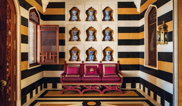 Theme of the Month: Antiques in a Contemporary Context. a wall of carved marble alcoves, each of which contains a sixteenth century Turkish blue and white mosque lamp and features Mashrabiya grillwork.