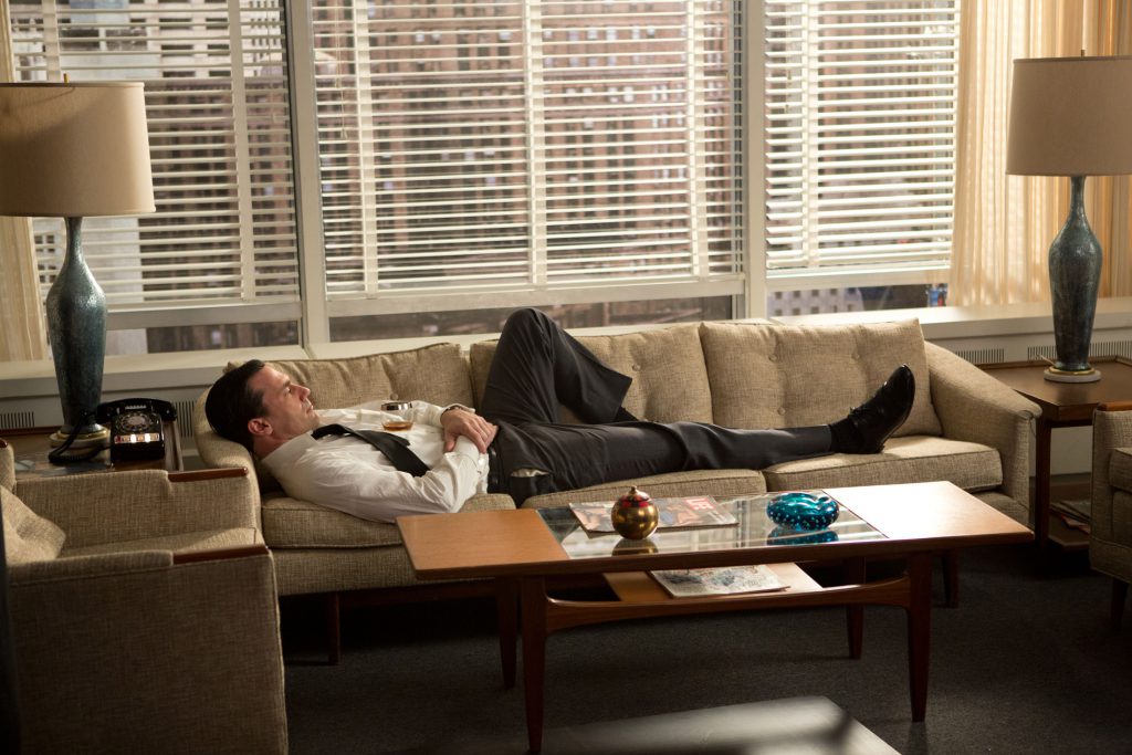In season 6, Don Draper (played by Jon Hamm) stretches out on his mid-century modern sofa between a pair of blue glazed ceramic lamps—the most expensive props bought outright. Photographer: Jamie Trueblood/AMC via Bloomberg